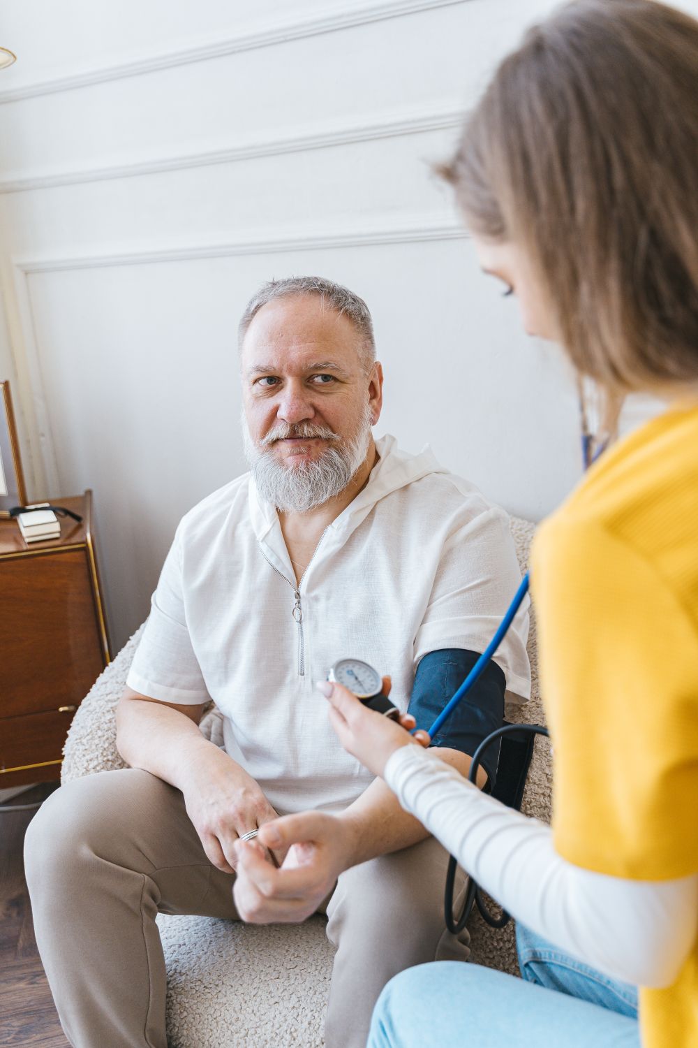 A PureCare caregiver attending to a senior client at home